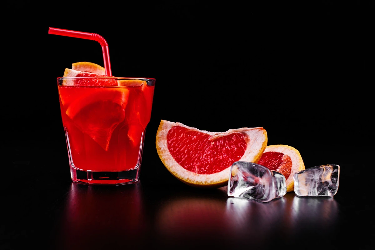 A glass of freshly squeezed blood orange juice with vibrant red-orange color.