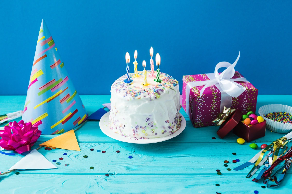 A beautifully decorated birthday cake with colorful frosting and candles