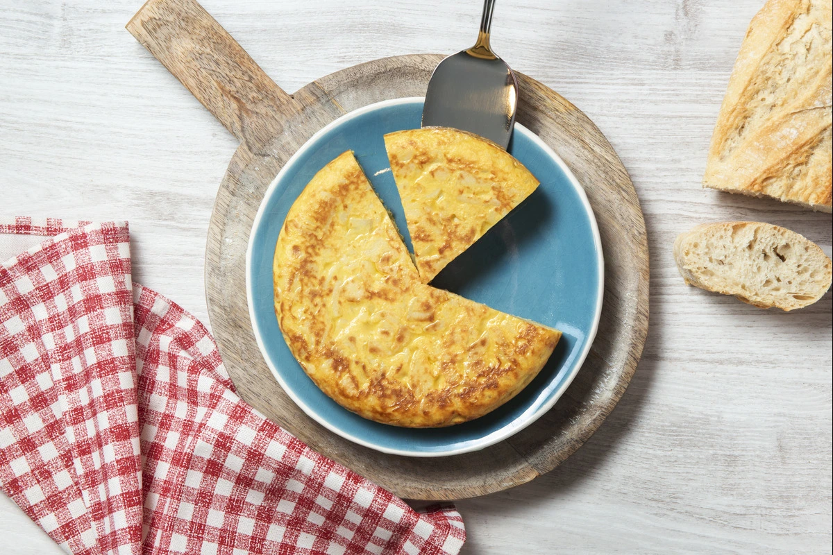 Golden and cheesy cornbread casserole served in a white baking dish