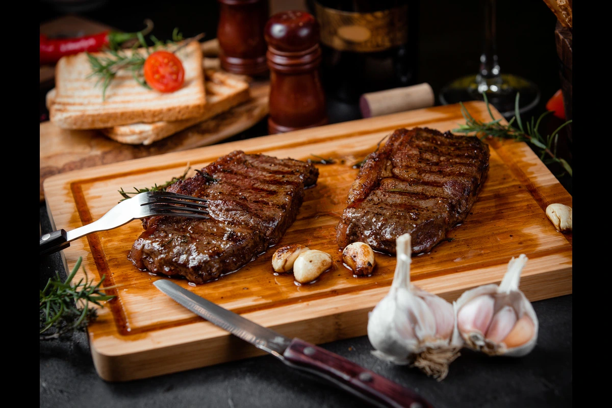 Perfectly cooked BBQ brisket served on a wooden platter with classic sides