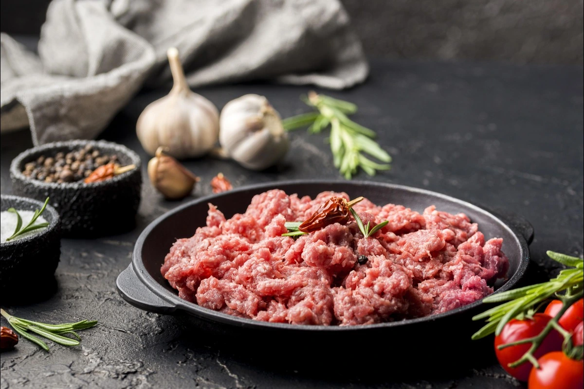 A bowl of ground beef Bulgogi served over rice with green onions and sesame seeds.