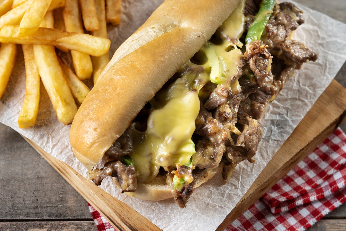 Crispy Philly cheesesteak egg rolls with melted cheese and sautéed onions and peppers