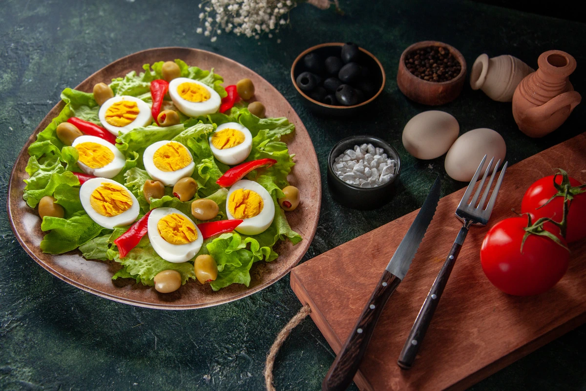 Freshly prepared egg salad in a bowl with sliced bread