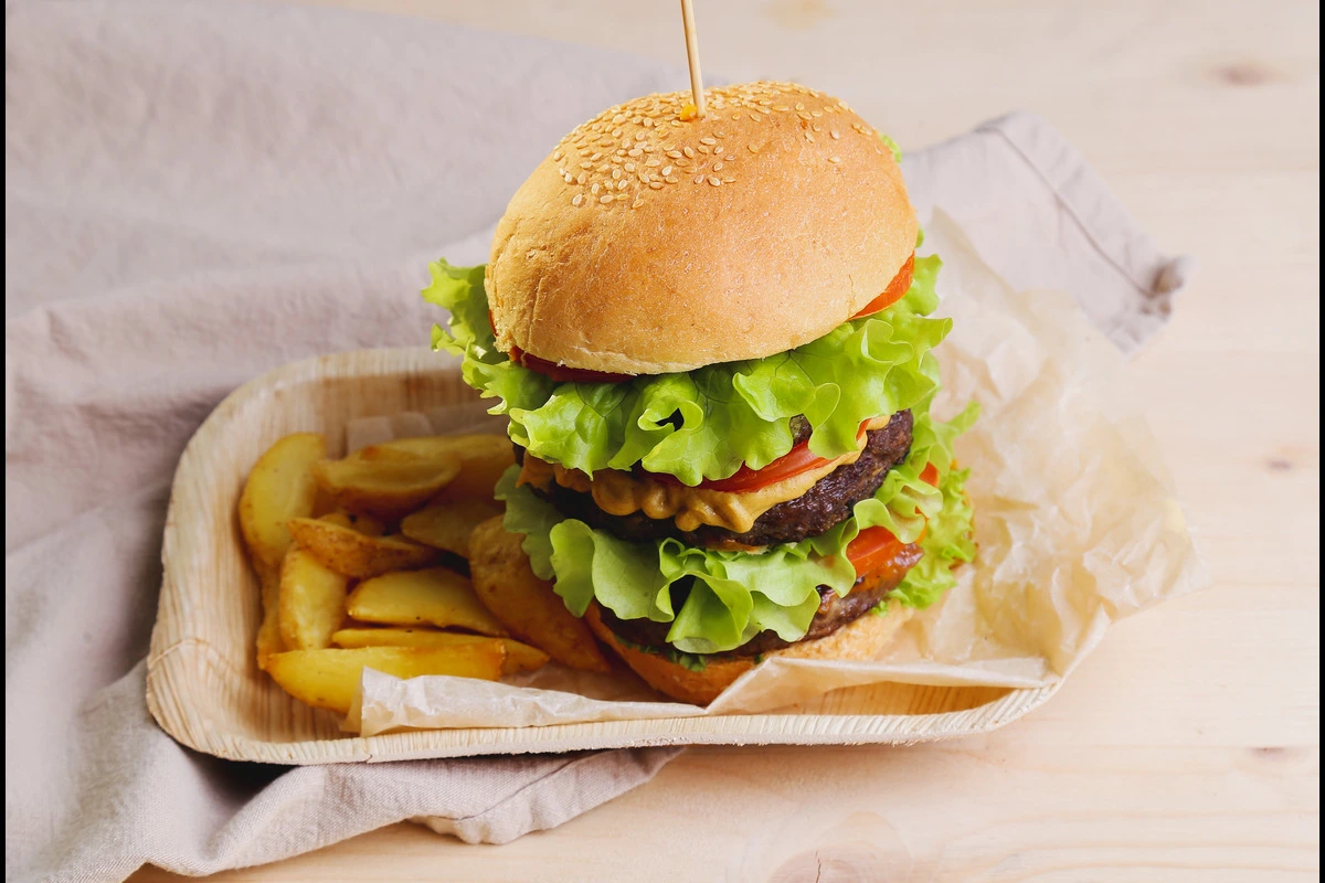 Juicy homemade cheeseburger with melted cheese, lettuce, and tomato