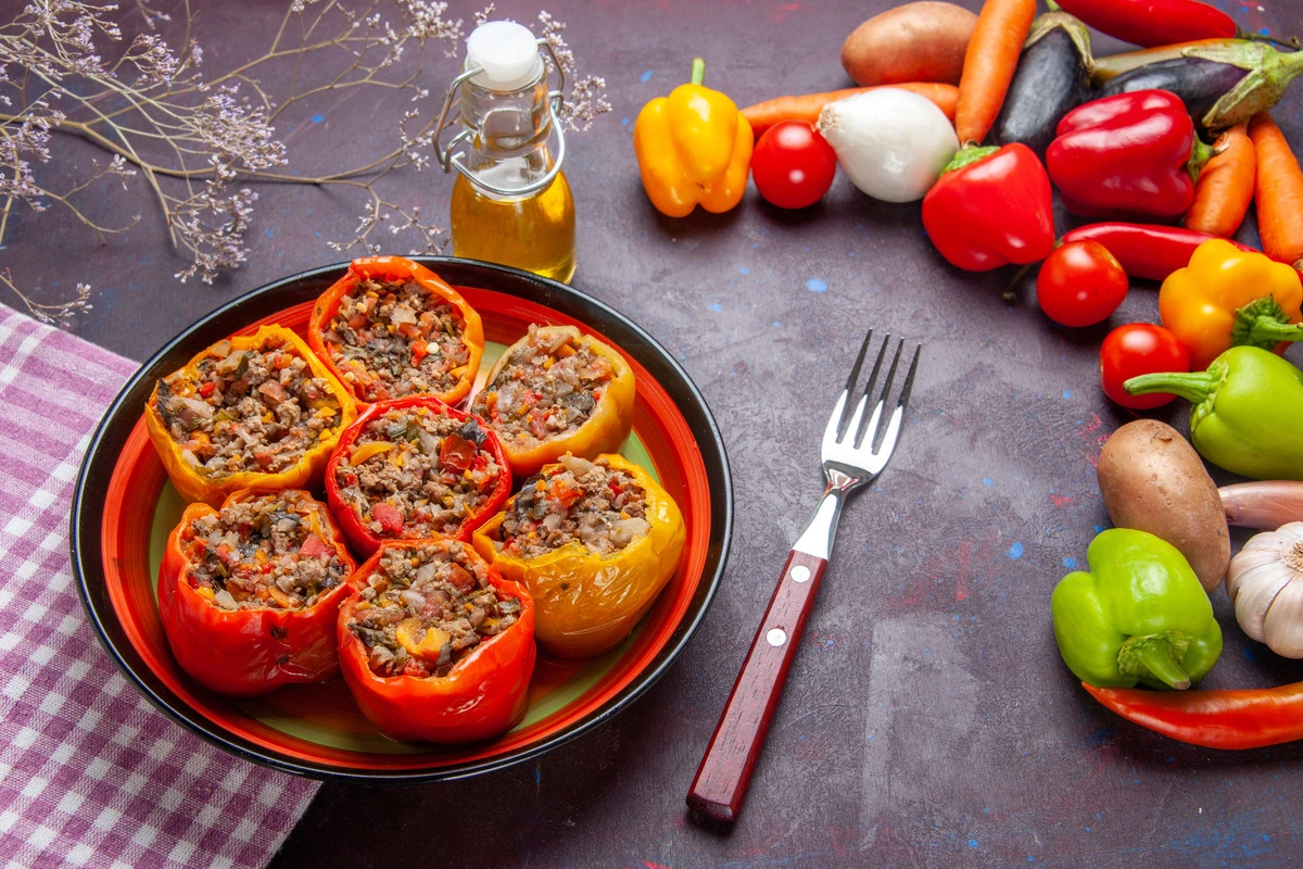 A close-up of baked stuffed bell peppers with melted cheese on top