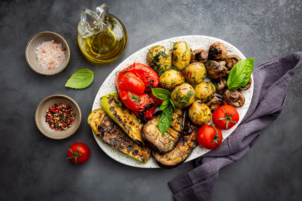 A colorful assortment of perfectly roasted vegetables on a baking sheet.