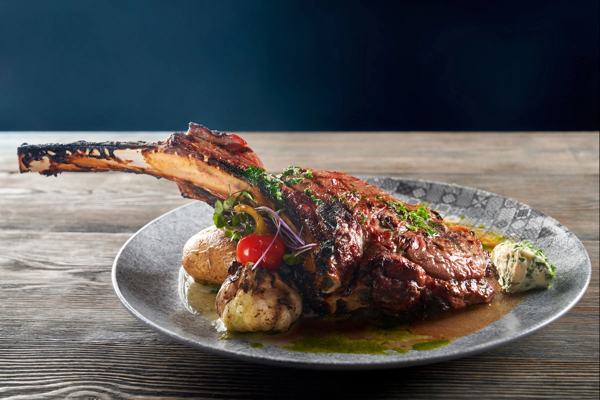 Beef shank on a wooden cutting board ready for cooking.