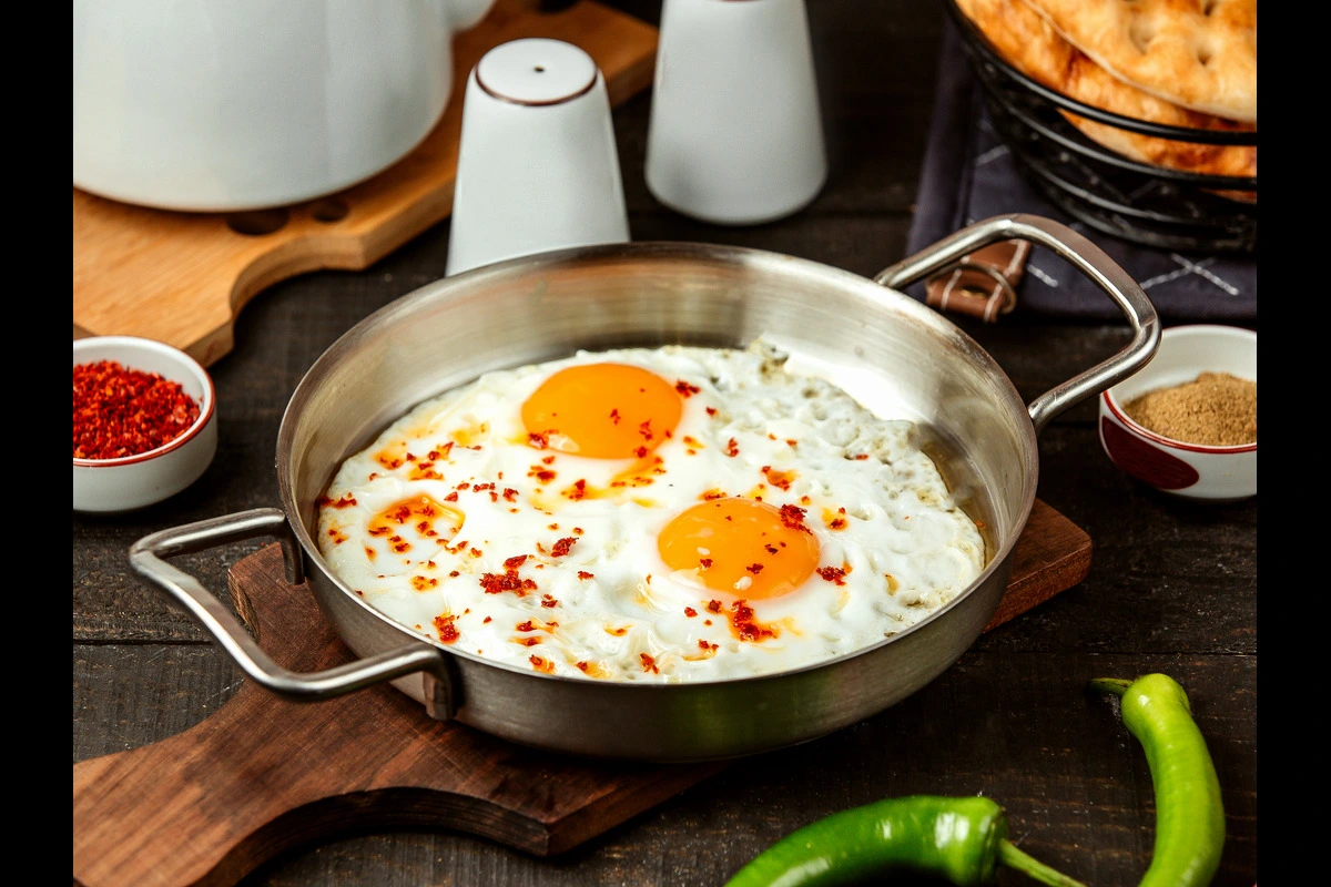 Perfectly cooked fried eggs in a skillet with crispy edges and runny yolk